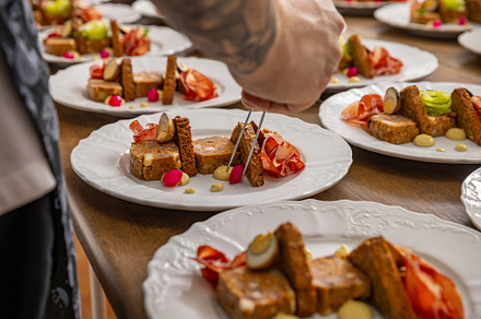 Chef in the midst of plating dishes, a Photo by Grafvision photography