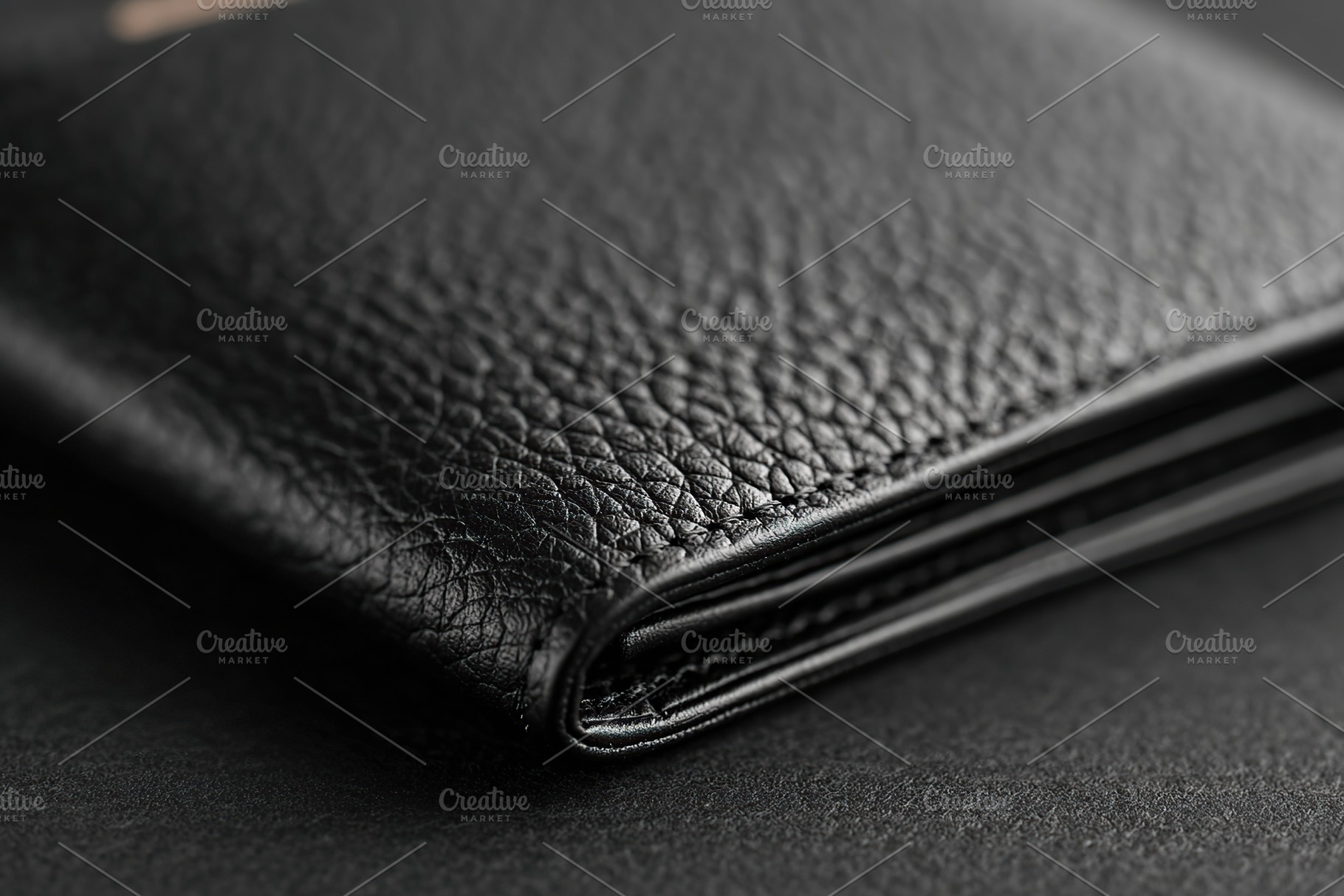 Elegant black leather wallet resting on a smooth surface in a minimalist enviro, a Beauty & Fashion Photo by AlyaAnd