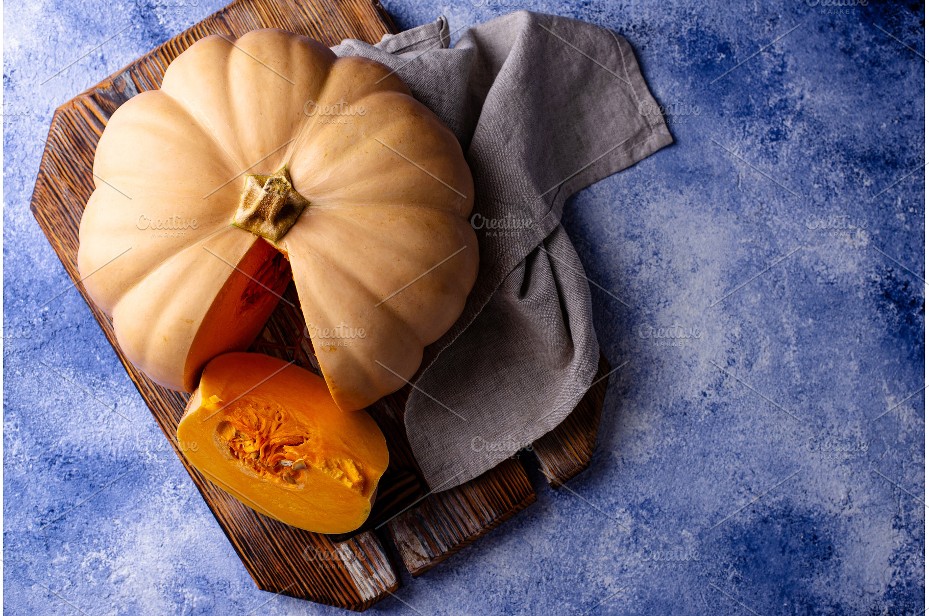 Raw fresh cut pumpkin on dark, a Food & Drink Photo by Yulia Furman