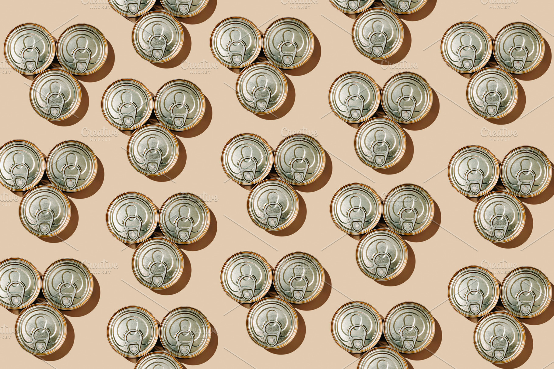 pattern of triangular groups of three food cans, a Photo by Nito