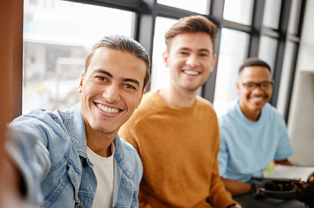 College students selfie, men friends and social media at university, school and campus. Diversity, happy portrait perspective and gen z young group taking photos for studying, education and learning, a Photo by Peopleimages.com