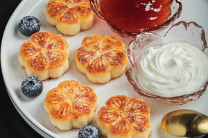 Cottage cheese pancakes, syrniki, curd fritters decorated with strawberry and r, a Food & Drink Photo by Budarinphoto