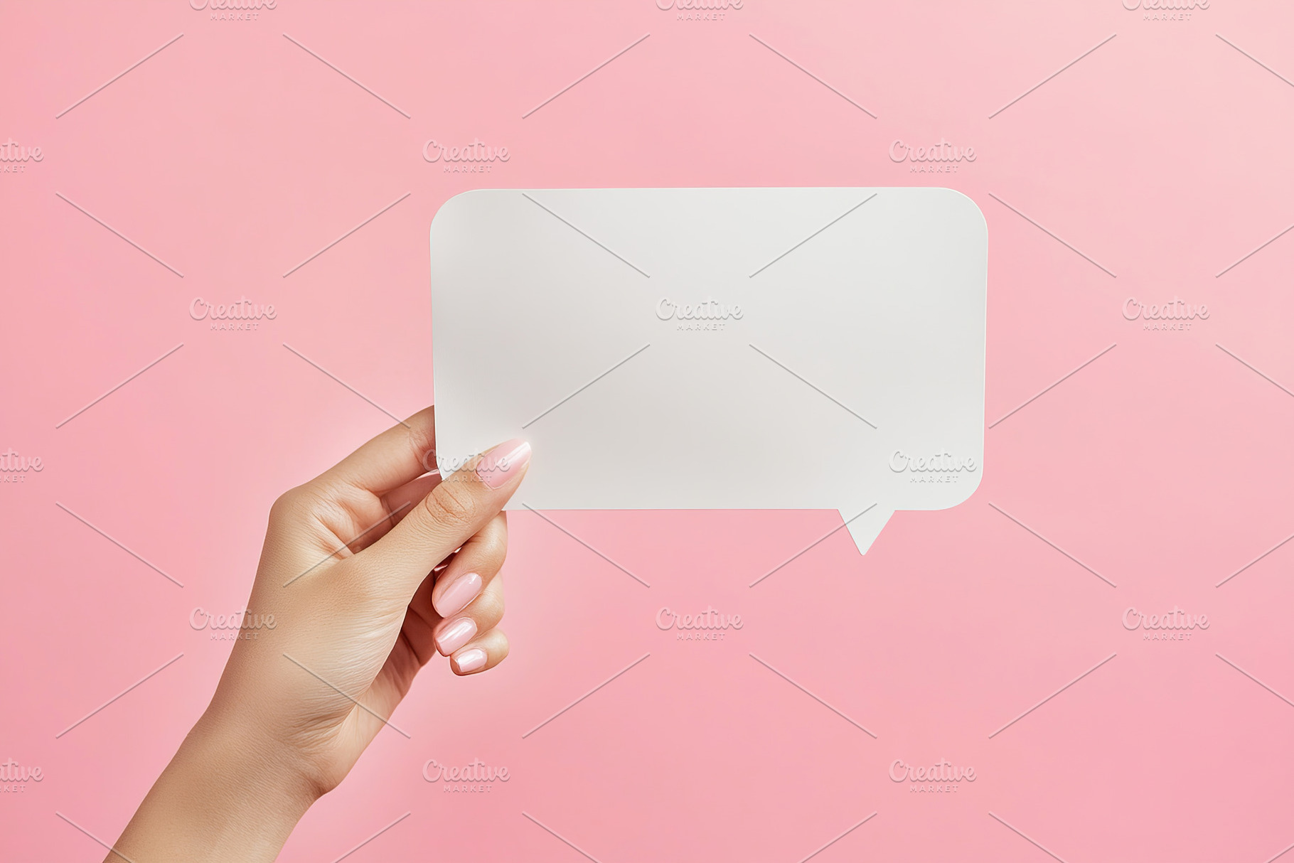 Hand holding a blank white speech bubble against a pink background in a creativ, a Background Photo by AlyaAnd