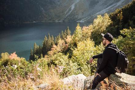 Man tourist relaxing on the top of a hill, a Person Photo by Olena Rudo