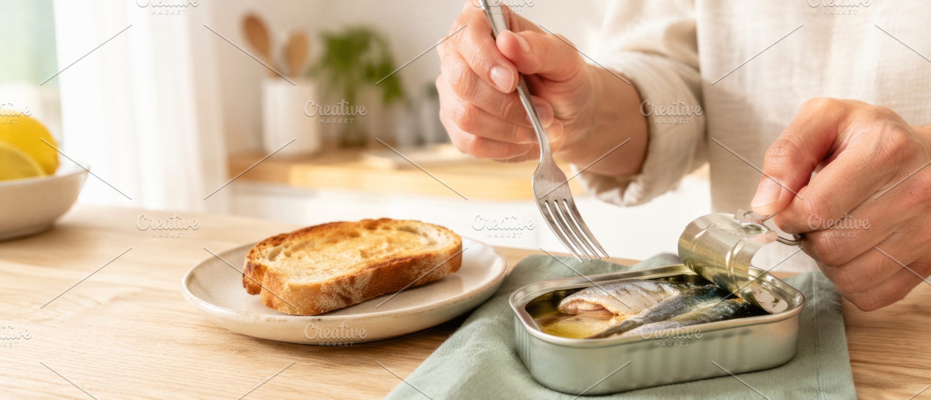 Opening canned sardines with fork in, a Photo by Dvoevnore photos