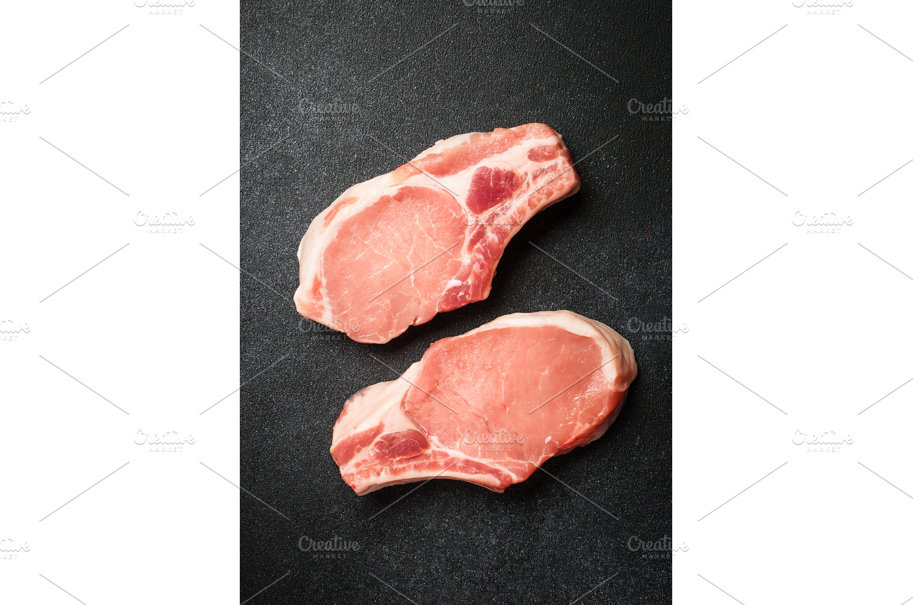 Raw pork meat steaks on black, a Food & Drink Photo by Nadia-nb