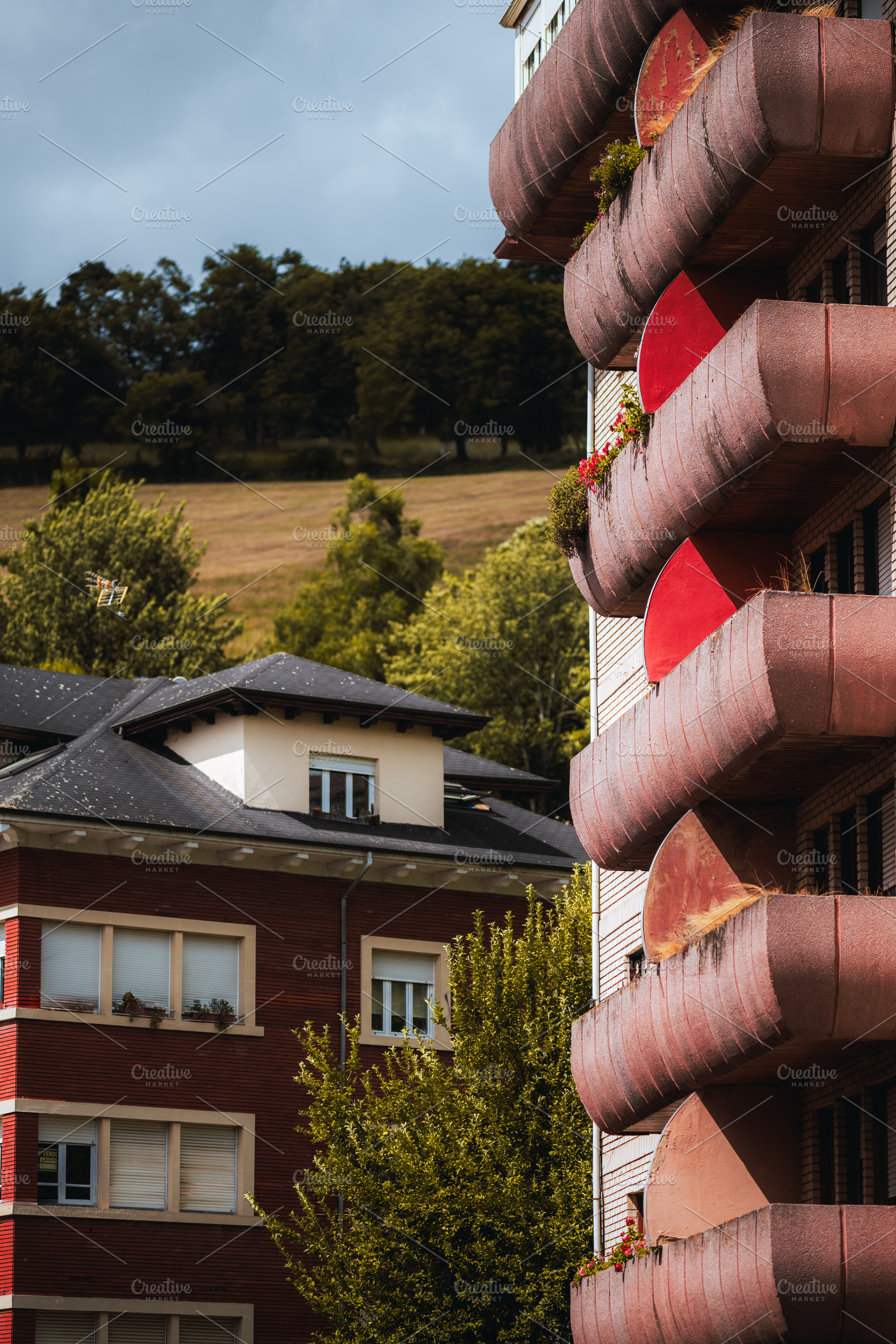 Curved red balconies and hills, an Architecture Photo by SkyNext