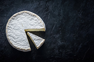 Soft cheese wheel with a slice cut o, a Photo by Iftikhar Alam