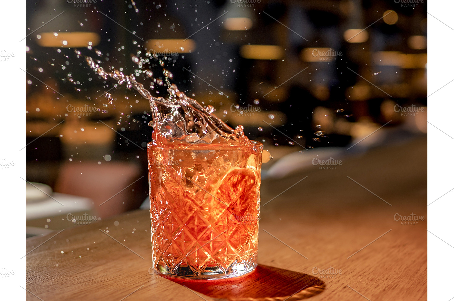 Red brown cocktail with splashes in, a Food & Drink Photo by Fascinadora