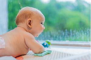 Little baby looking through a window, a Person Photo by Elizaveta Galitskaya