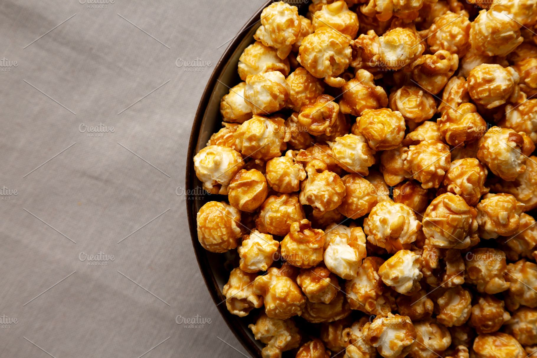 Homemade Caramel Pop Corn in a Bowl, top view., a Food & Drink Photo by LiudmylaChuhunova