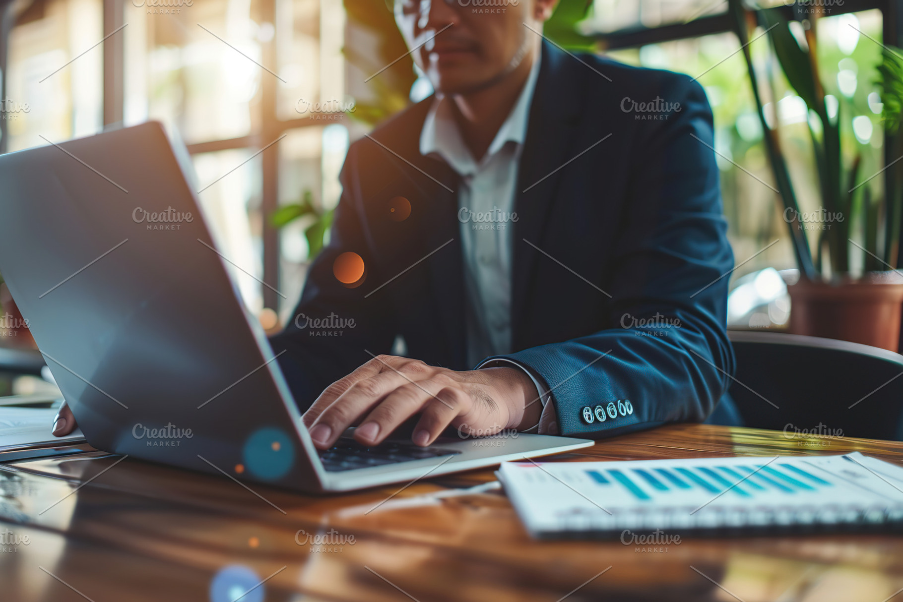 Businessman working on laptop in modern office, a Business Photo by AlyaAnd