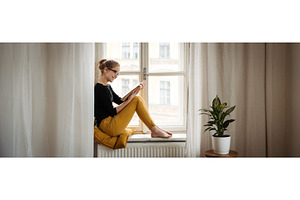 Student reading textbook sitting on, a Person Photo by HalfPoint