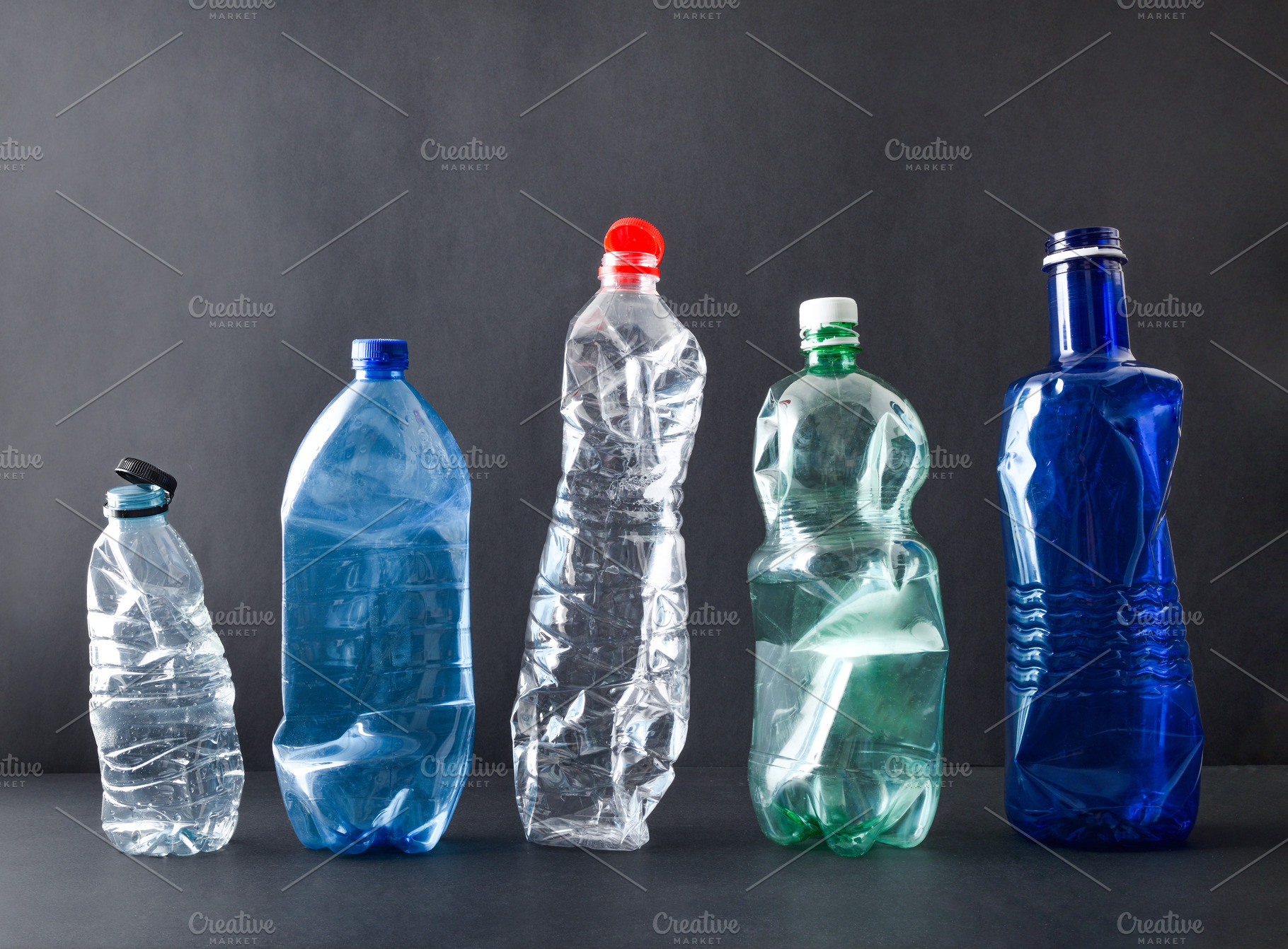 Row of plastic bottles isolated on a black background, a Nature Photo by Davizro's Market