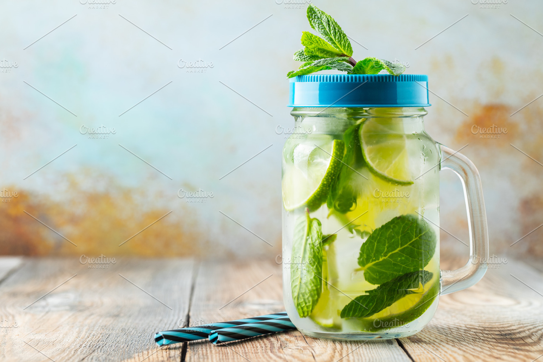 Mojito cocktail with ice cubes in a featuring cocktail, mojito, and lime, a Food & Drink Photo by Budarinphoto