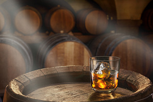 Glass of whiskey on top of barrel, a Food & Drink Photo by Volff