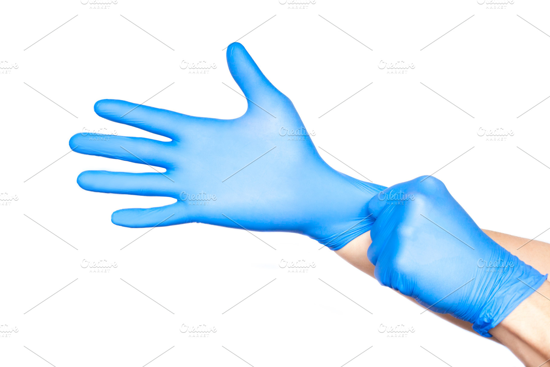 Doctor putting on gloves isolated on containing background, blue, and care, a Health & Medical Photo by telnyaw