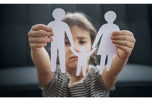 Child with a paper family in his, a Person Photo by yanadjana
