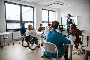 Teacher in inclusive classroom, a School & Education Photo by HalfPoint