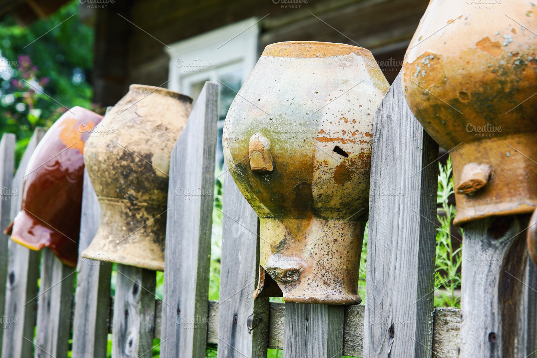 Old broken clay jugs on wooden fence, a Food & Drink Photo by BOOCYS