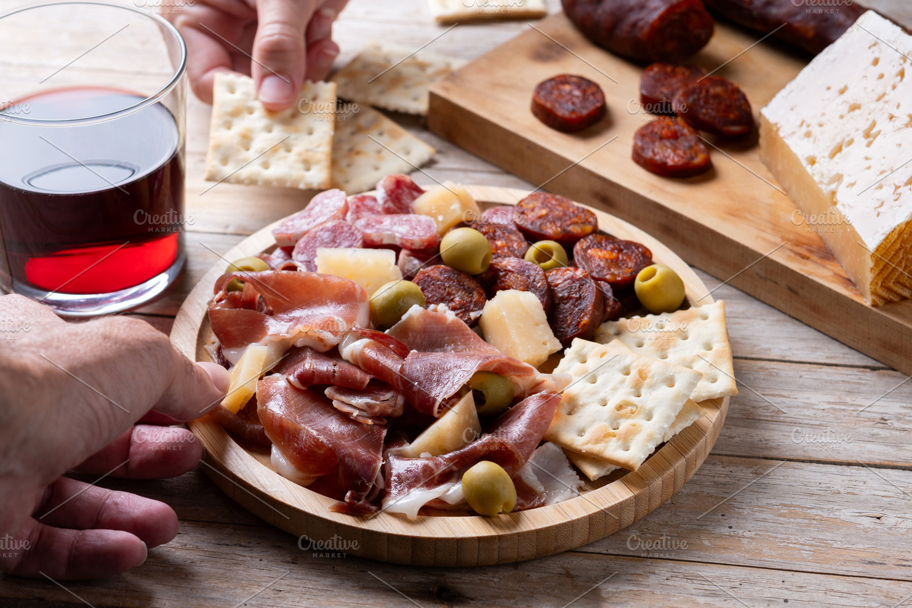 People sharing Spanish charcuterie board with ham, chorizo and cheese, a Food & Drink Photo by etorres69