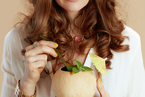 happy woman in blouse and shorts on beige, a Person Photo by Alliance Images
