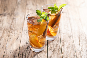 Refreshing peach iced tea in glass with ice cubes and cinnamon, a Food & Drink Photo by etorres69