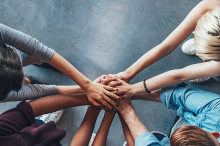 Stack of hands symbolizing trust containing above, achievement, and college, a School & Education Photo by Jacob Lund
