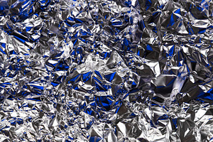 Shiny crumpled silver foil with blue, an Abstract Photo by Edalin's Store
