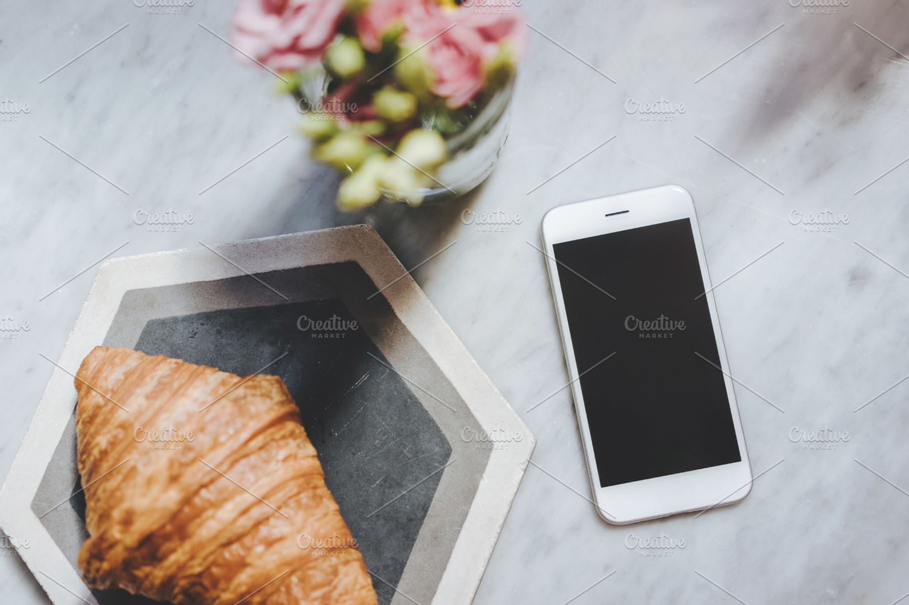 Phone with croissant and flowers, a Technology Photo by Anastasia Dudka