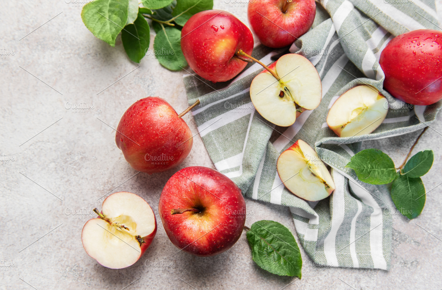 Red apples on striped cloth showing freshness and health, a Food & Drink Photo by Olena Rudo