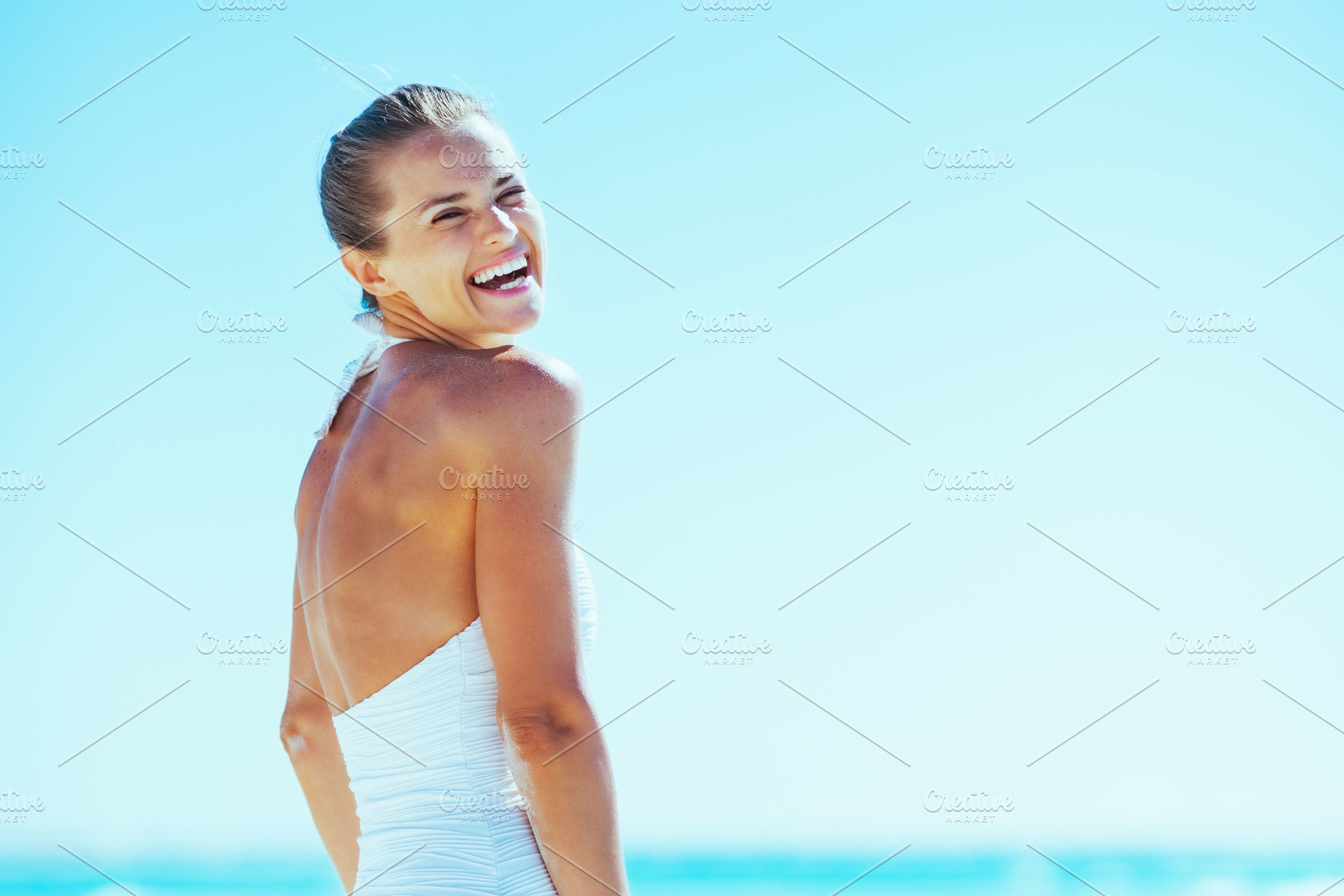 smiling young woman on sea shore, a Person Photo by Alliance Images