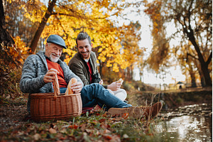 Adult son and father having picnic, a Nature Photo by HalfPoint