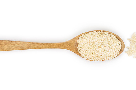 Sesame seeds in a wooden spoon containing sesame, isolated, and grain, a Food & Drink Photo by NataPhoto