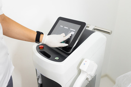 Setting the laser for hair removal, a Technology Photo by borodai94