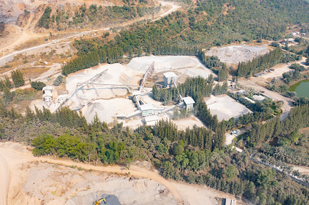 Aerial view of machine excavator trucks dig coal mining or ore w, a Background Photo by Tampatra
