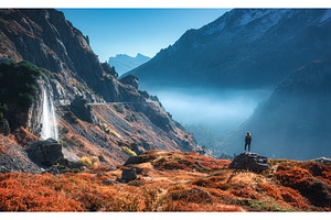 Woman standing on rock near a, a Nature Photo by den-belitsky