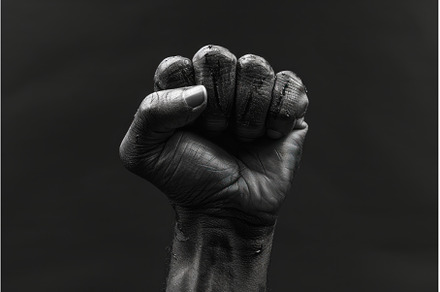Powerful Black hand fist clenched, a Person Photo by Ylivdesign
