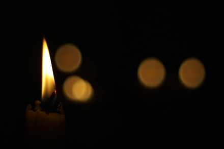 Candle containing dark, flame, and black