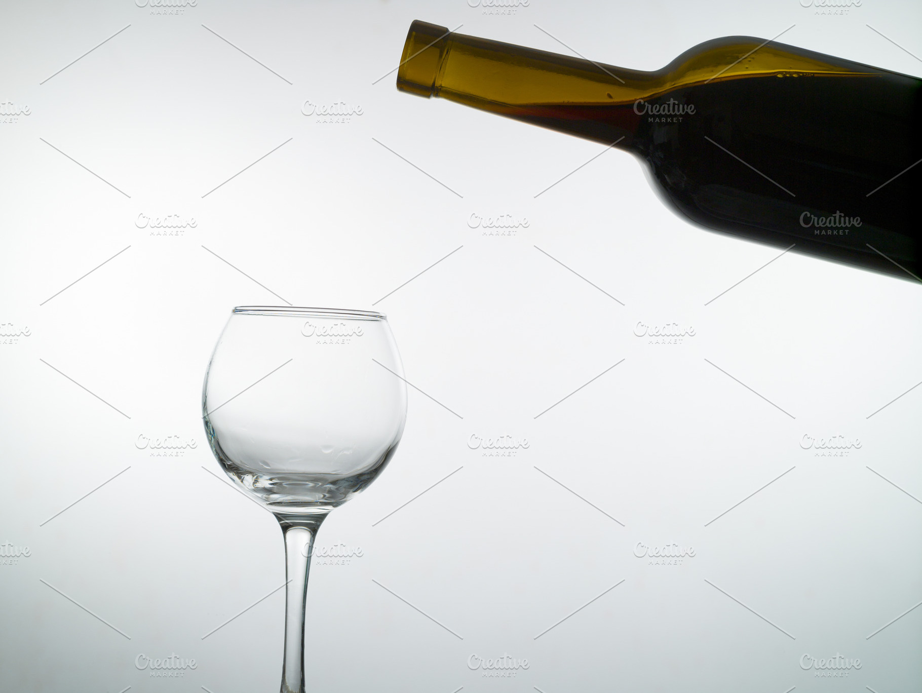 Red wine pouring into a wine glass containing wine, red, and drink, a Food & Drink Photo by oleghz