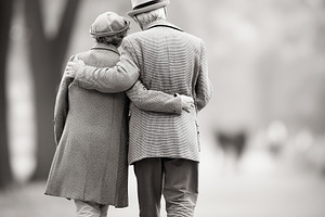 Elderly couple walking arm in arm, a Person Photo by MistyDay