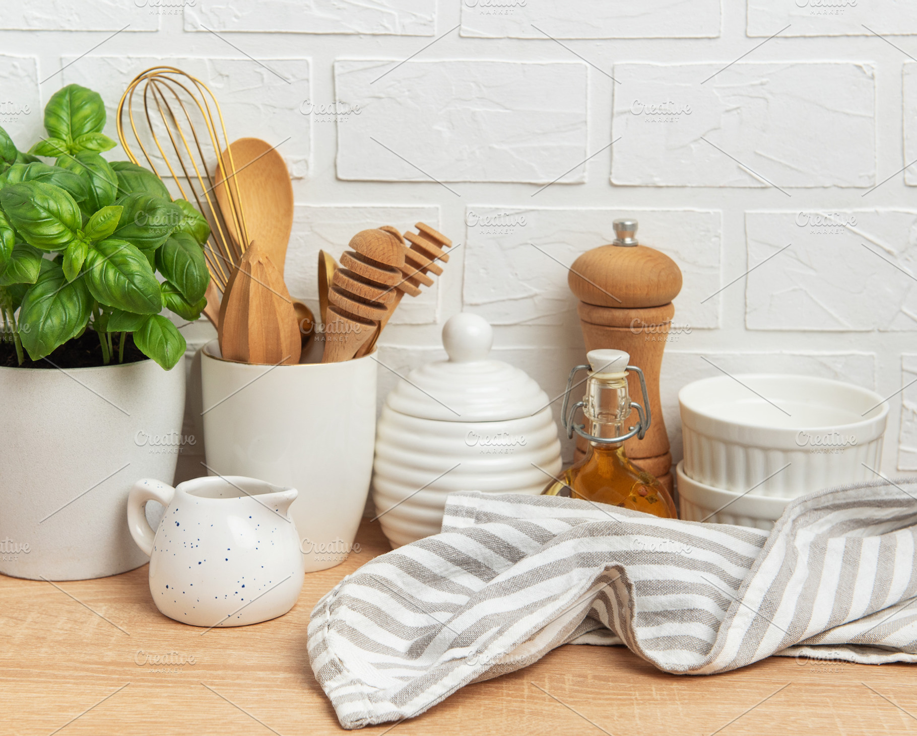 Kitchen utensils, basil plant and linen napkin creating cozy atm, a Food & Drink Photo by Olena Rudo
