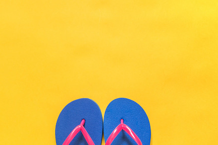 Flip flops on a yellow background featuring travel, vacation, and background