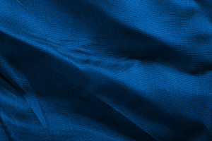 Close-up of elegant blue fabric with flowing folds and subtle te, a Background Photo by Ales Munt