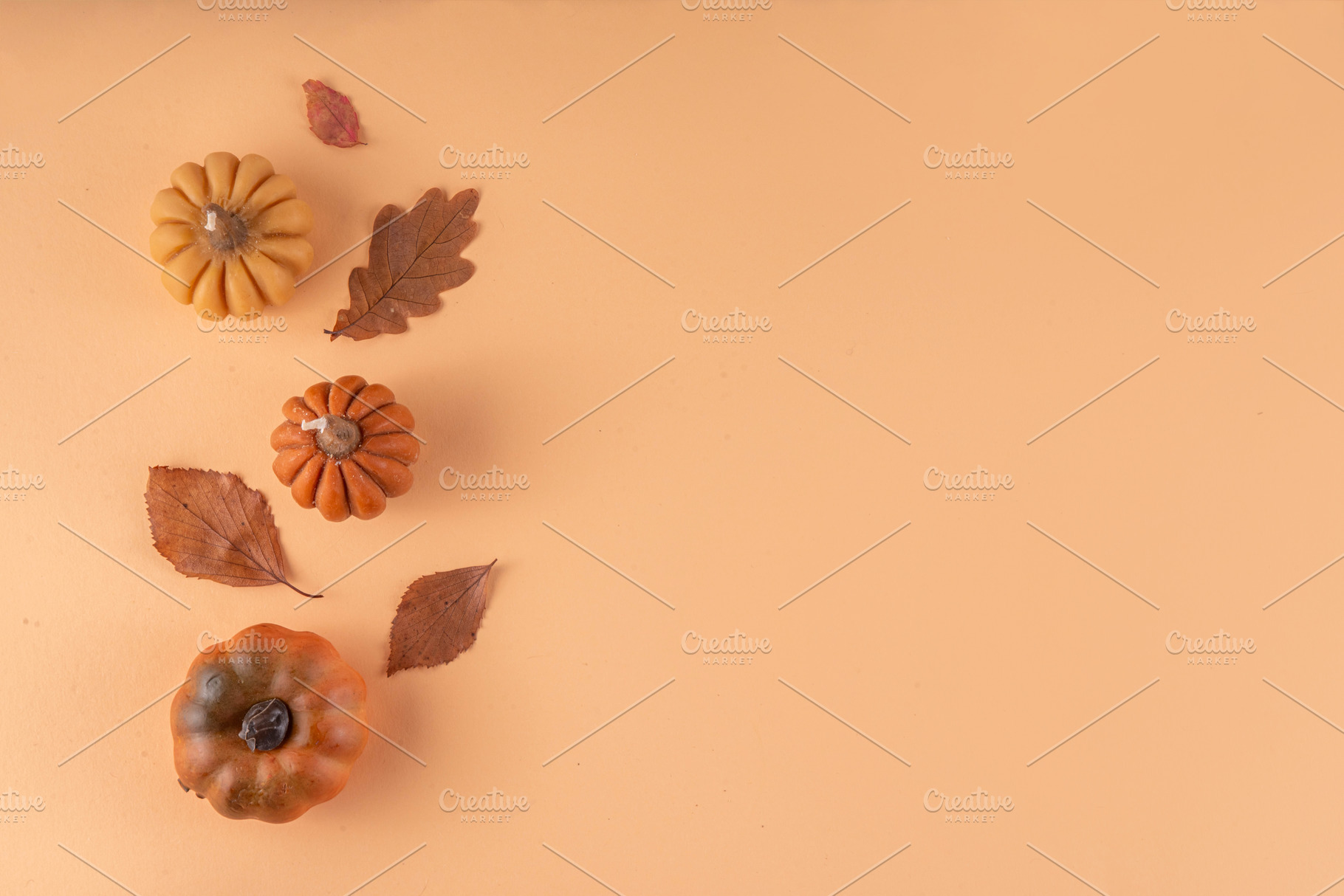 Autumn leaves and pumpkins flat lay on beige background, a Holiday Photo by Rimma