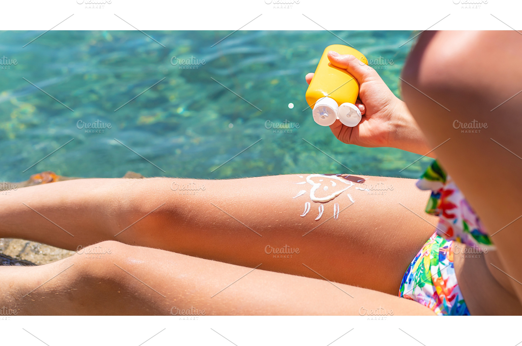 The child has sunscreen on his legs, a Person Photo by yanadjana