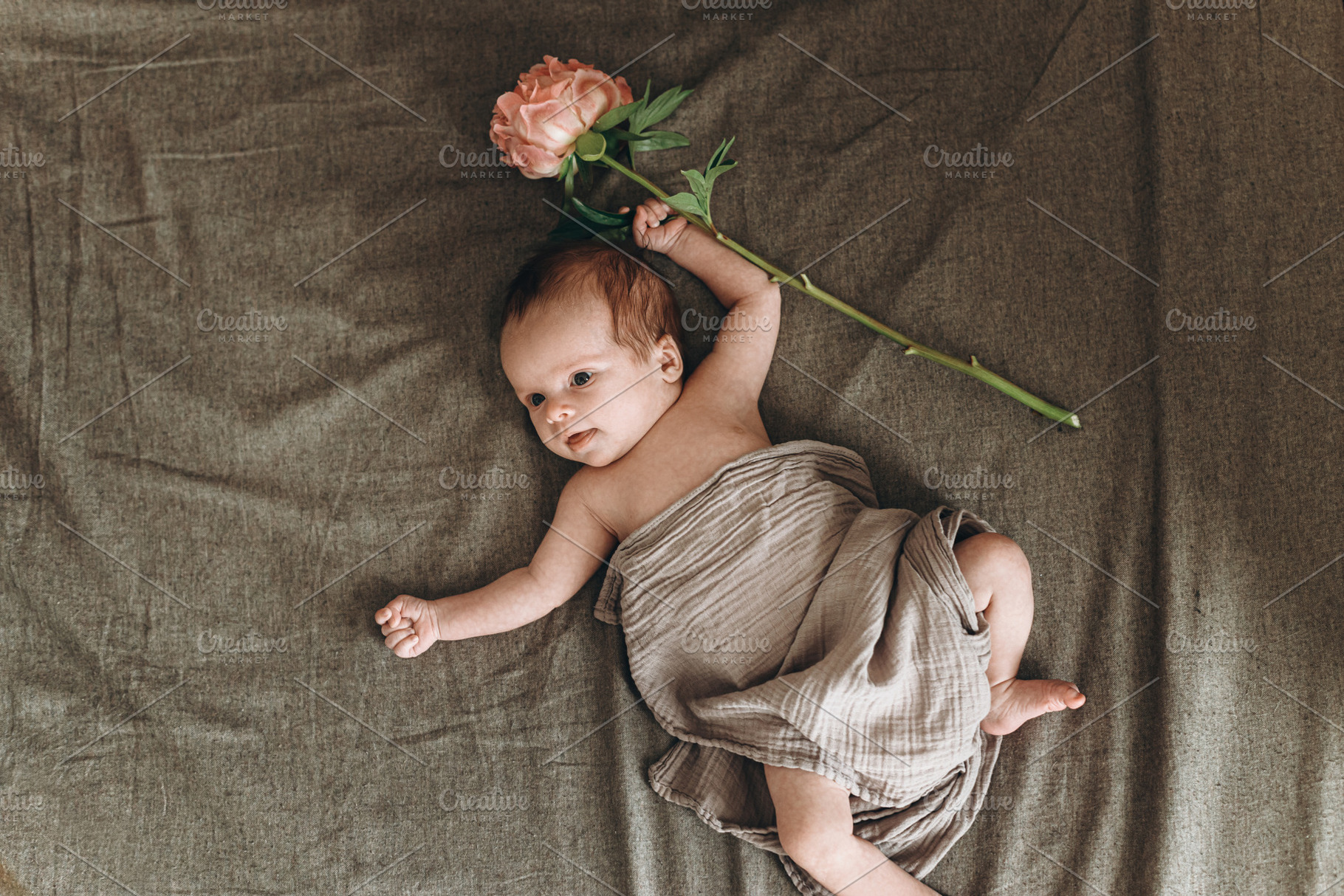 Happy Mothers day! Cute little baby with flower lying on brown b, a Person Photo by Sonjachni