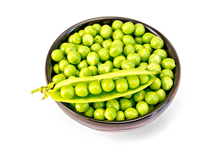 Green peas in brown bowl with pod, a Food & Drink Photo by rezkrr