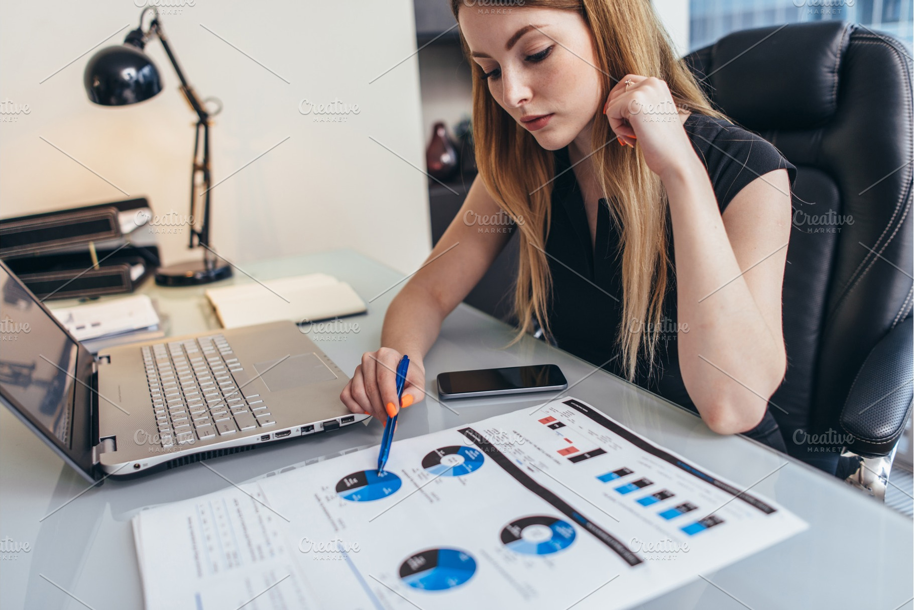 Female businesswoman readind financial report analyzing statistics pointing, a Business Photo by undrey