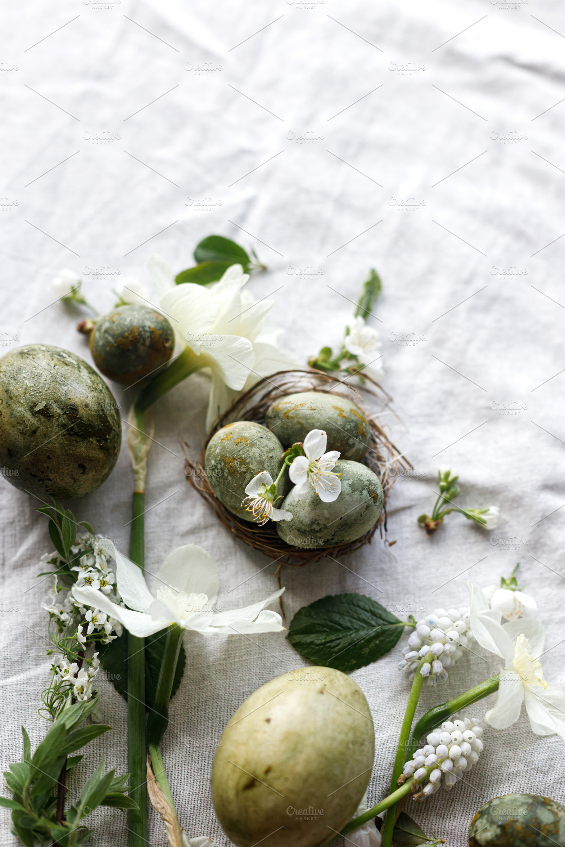 Happy Easter! Stylish natural dyed eggs and spring flowers on li, a Holiday Photo by Sonjachni